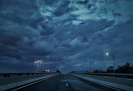 暴风雨天深蓝忧郁的天桥和路灯背景图片