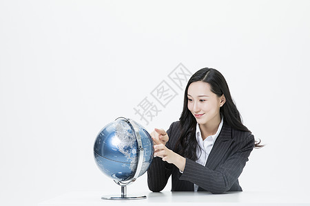商务女性看着地球仪图片