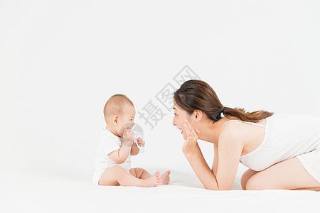 婴儿插画母婴妈妈在床上逗宝宝开心背景