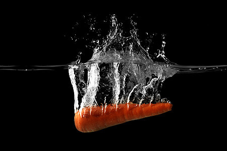 一个掉落水中的胡萝卜背景图片