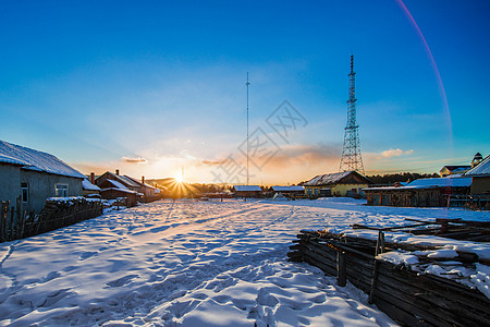 雪地村庄北极村冬天的日落背景