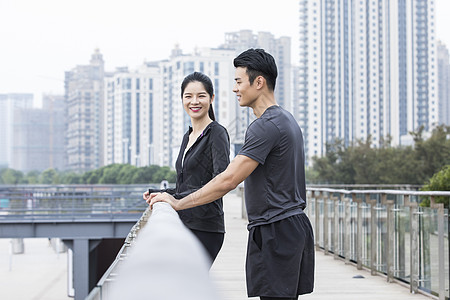 青年男女扶栏休息聊天背景图片