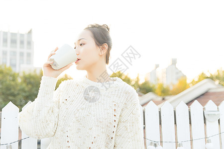 夕阳海年轻女性喝水背景