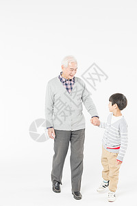 陪伴老人祖孙情爷爷和孙子牵手走路背景