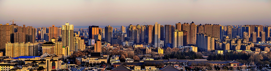 高层小区夕阳下大城市林立的高楼大厦背景