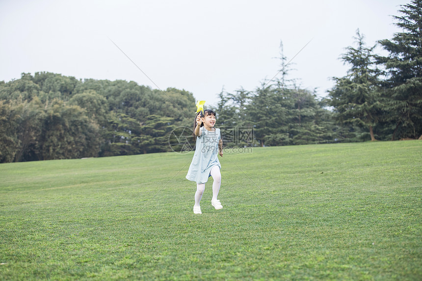 拿着风车奔跑的小女孩图片