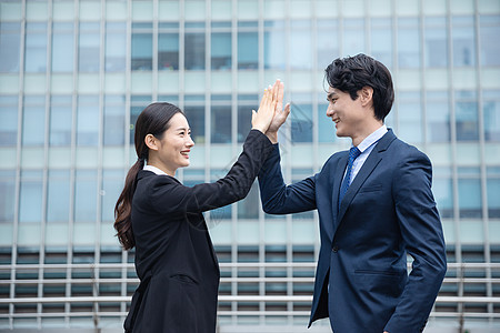 商务女士商务男女击掌庆祝背景