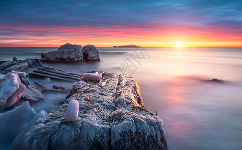 海边夕阳岩石海岸风光背景