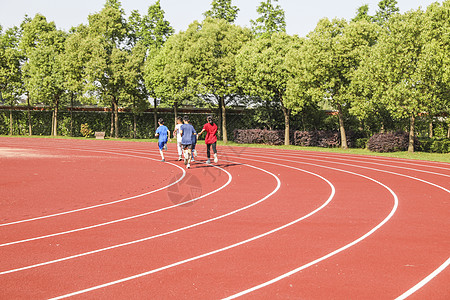 跑步运动学校操场跑道和正在跑步的学生背景