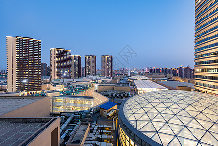 酒店外观华灯初上的城市夜景背景