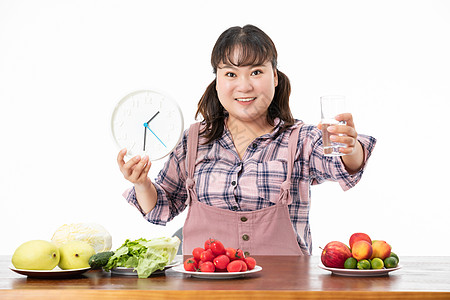 拿着闹钟女生胖女生健康饮食背景