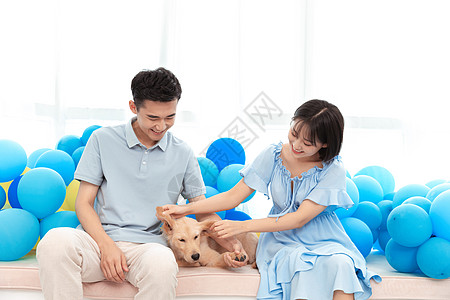 情侣坐在气球上一对情侣坐在飘窗台抚摸宠物狗背景