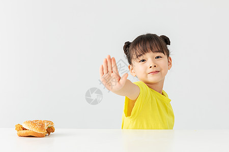 吃垃圾食品小女孩拒绝吃汉堡包手势背景