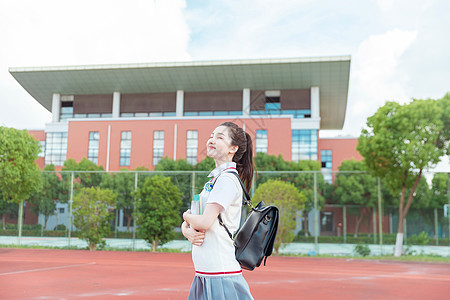 文艺女清新女高中生在操场散步背景