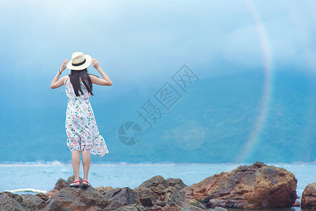 海中岩石上的美女深圳西冲情人岛礁石上的少女背影背景