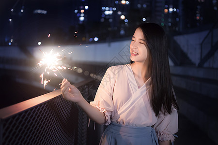 女孩夜景手持仙女棒的少女背景