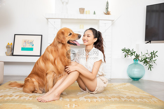 年轻美女和金毛犬快乐相伴图片