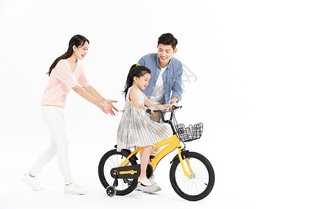 儿童骑爸爸妈妈教女儿骑自行车背景