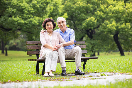 一对老人背影恩爱老年夫妇在公园背景