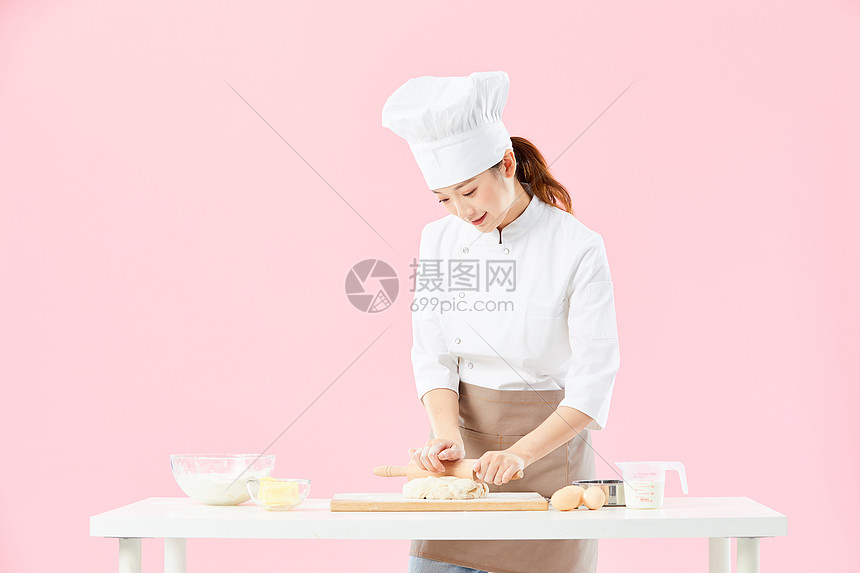 女面点师用擀面杖擀面图片