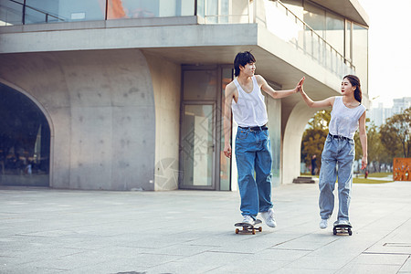街头模特情侣户外玩滑板背景