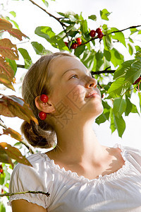 在樱桃树上拍照的女孩图片