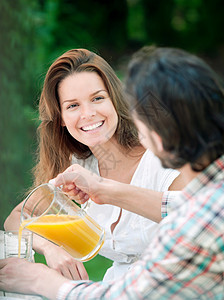 男人和女人户外喝橙汁图片