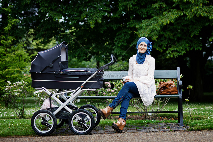 带婴儿车的妇女在公园里图片