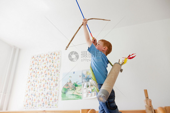 玩玩具弓和箭的男孩图片