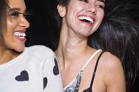 两个年轻女人一起笑的特写镜头图片