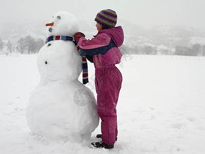 雪人在滑雪女孩给雪人系围巾背景