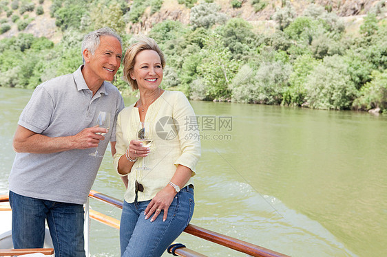 在船上度假时带着酒杯的老年夫妇图片