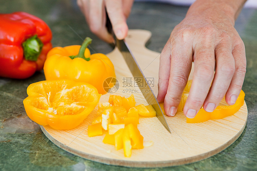 女人在菜板上切辣椒图片