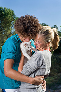 年轻夫妇与小猫拥抱图片