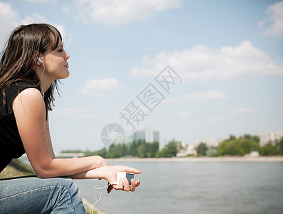 在河边听音乐的女人图片