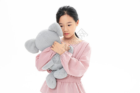 难过的女孩抱着玩具小象孩子高清图片素材