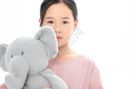 难过的女孩抱着玩具小象中国人高清图片素材