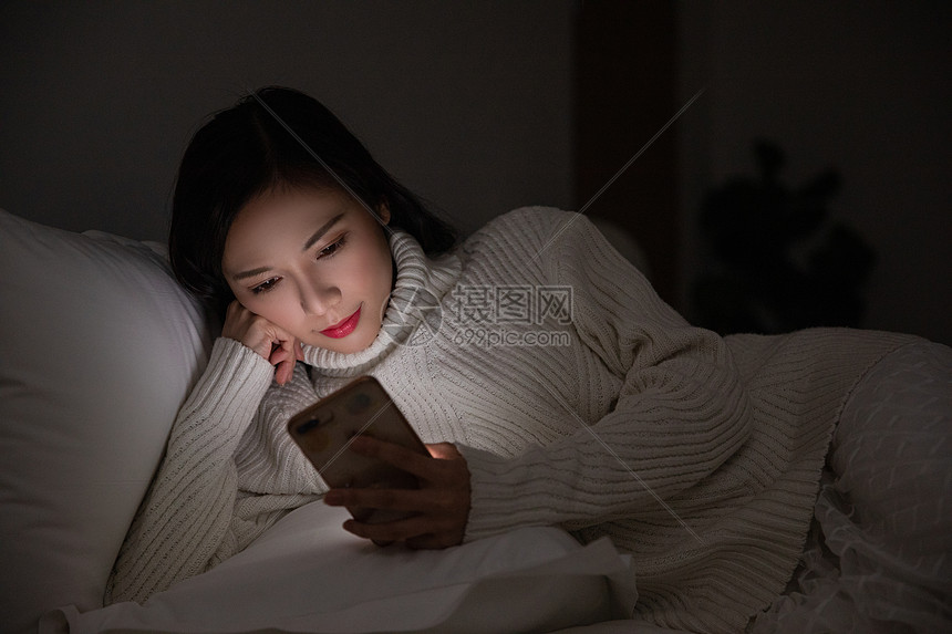 青年女性夜晚熬夜玩手机图片
