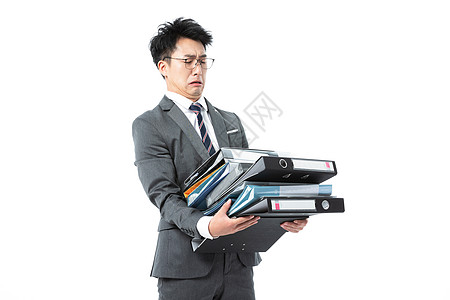 商务男性抱着许多文件高清图片