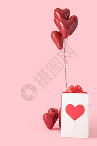 情人节爱心气球粉色背景下的情人节礼物盒背景