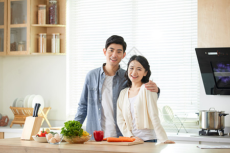 夫妻厨房做饭年轻夫妻在厨房一起备菜背景