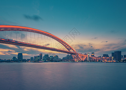 橙色城市上海卢浦大桥夕阳夜景背景