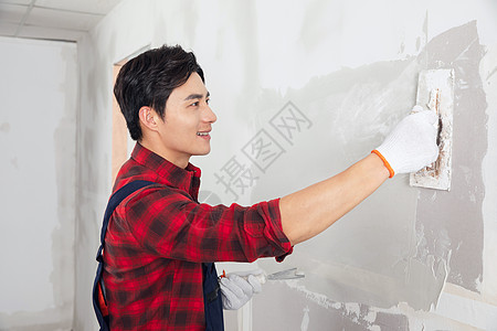 刷墙的工人装修工人涂擦墙腻子刷墙背景