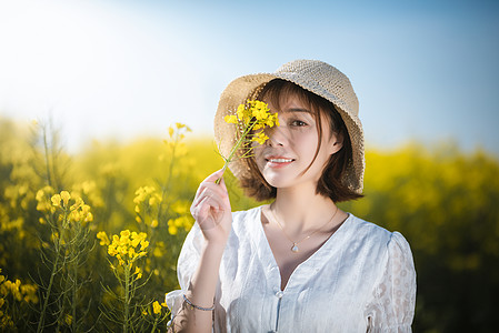 温馨美女油菜花春景美女背景