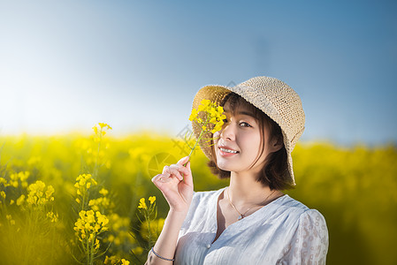 老年旅行唯美油菜花春游白裙微笑美女背景