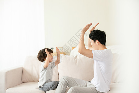 父子沙发上亲密击掌拍手游戏高清图片