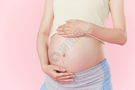 孕妇手扶肚子高清图片