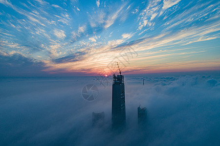 云层之上航拍平流雾之上的城市高楼背景