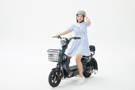 美女戴头盔骑行电动车背景图片