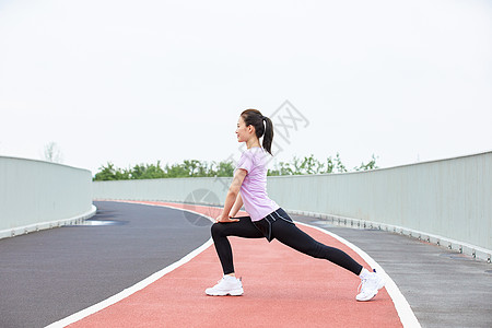 准备运动青年女性户外热身压腿背景